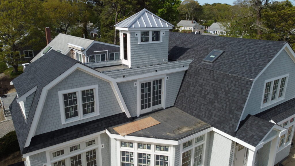 Hyannis Port home with painted white cedar siding and gray metal dome roof